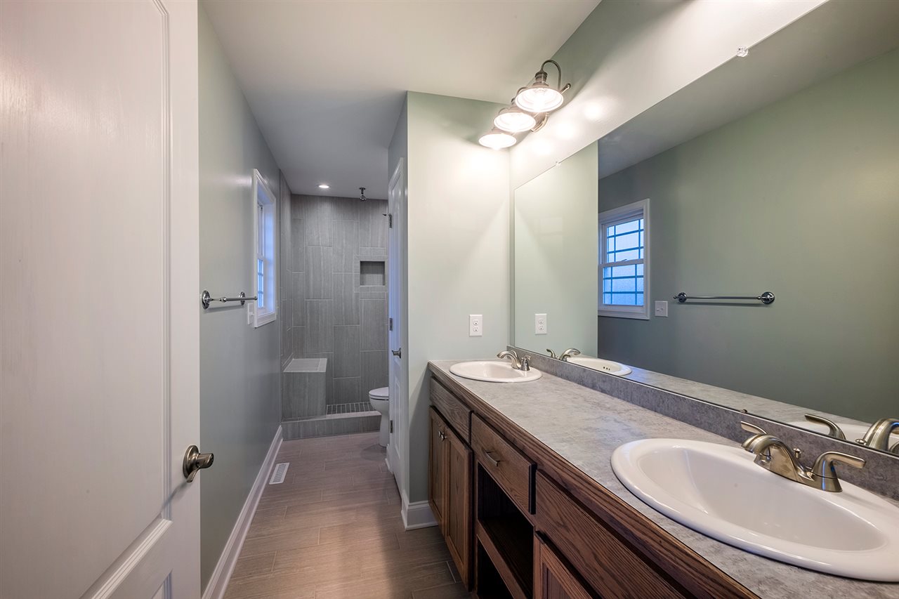 8 North Point School Road Waynesboro, VA 22980 - Photo 20 of 40 a bathroom with a granite countertop sink a mirror and a shower