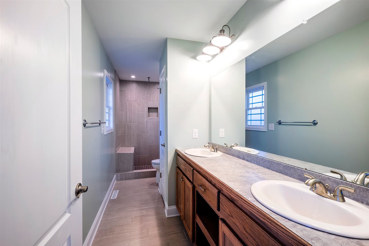 8 North Point School Road Waynesboro, VA 22980 - Photo 21 of 40 a bathroom with a granite countertop sink a mirror and a shower