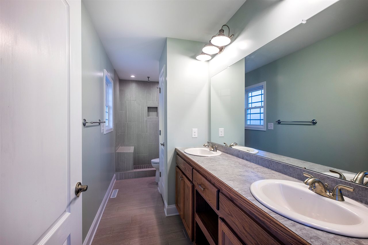 8 North Point School Road Waynesboro, VA 22980 - Photo 22 of 40 a bathroom with a granite countertop sink a mirror and a shower
