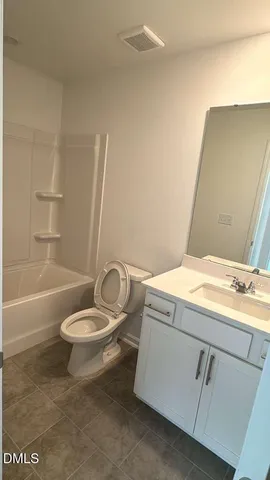 a bathroom with a granite countertop sink toilet and a bathtub