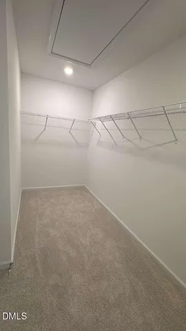 a view of an empty room with a staircase