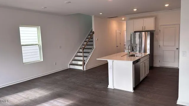 a kitchen with sink a stove and refrigerator