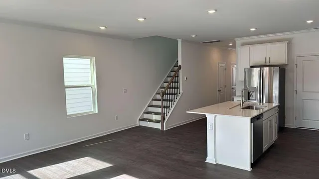 a kitchen with kitchen island a sink stainless steel appliances and cabinets