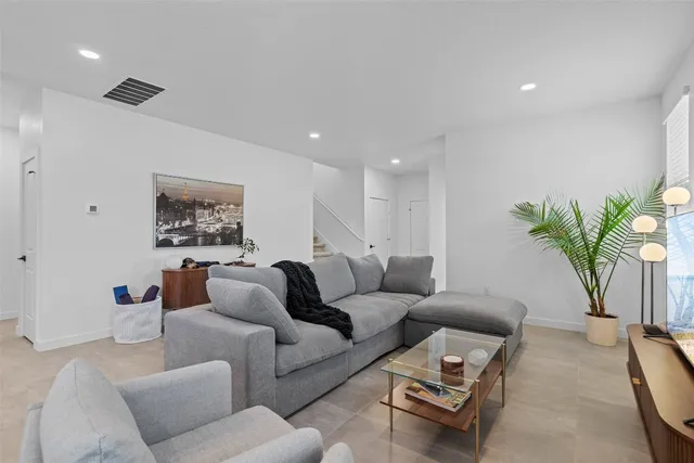 a living room with furniture and a potted plant