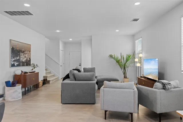 a living room with furniture and a potted plant