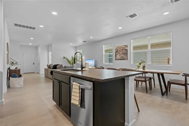 a kitchen with counter top space and dining table