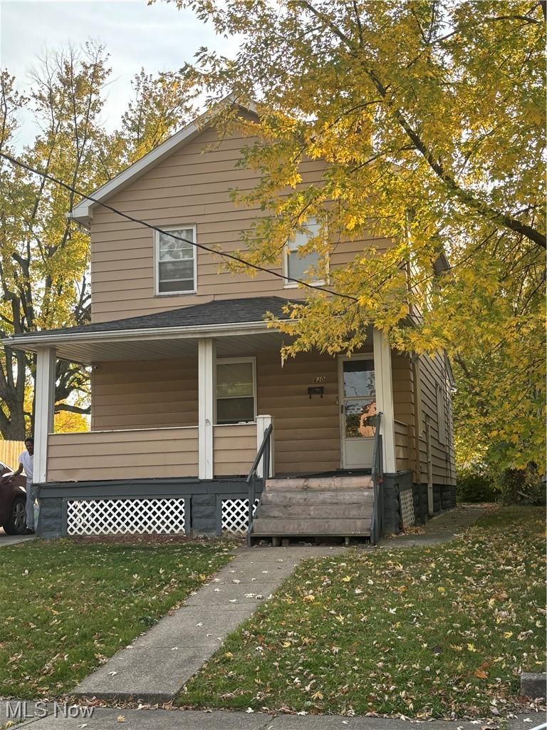 820 Whitcomb Road Cleveland, OH 44110 - Photo 1 of 1 View of front facade with a porch and a front lawn