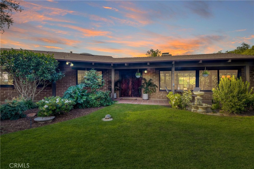 a view of a backyard with table and chairs and potted plants