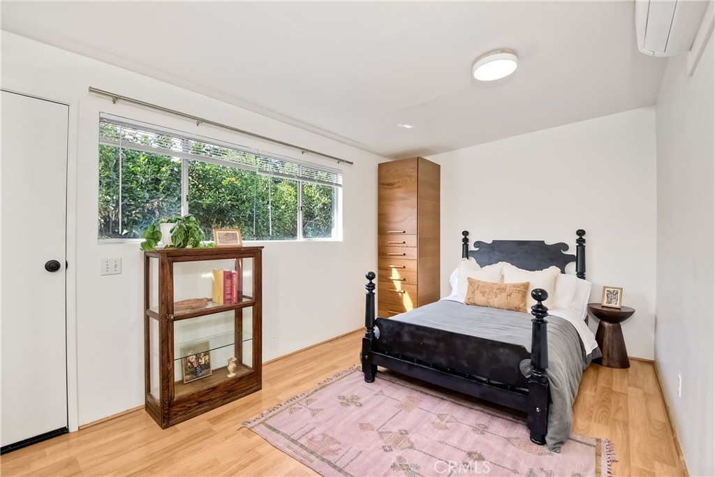 762 Hamilton Lane Fallbrook, CA 92028 - Photo 30 of 39 a bedroom with a bed and wooden floor