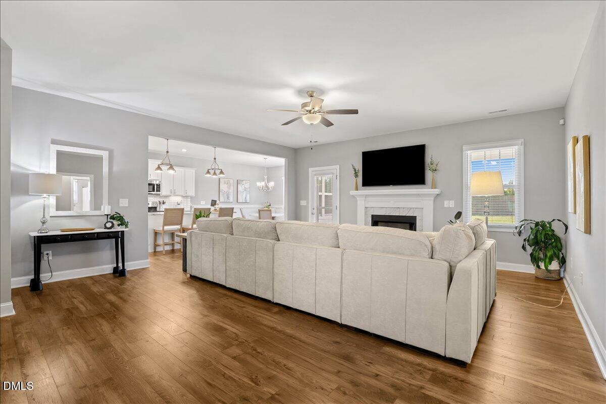 88 Heath Road Lillington, NC 27546 - Photo 29 of 54 a living room with furniture a fireplace and a flat screen tv