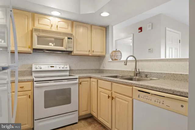 a kitchen with a stove top oven sink and cabinets