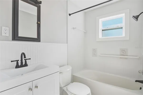 a bathroom with a sink toilet a mirror and shower