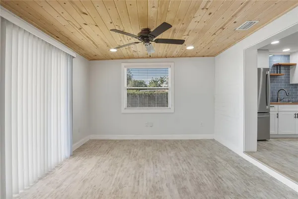 a view of a livingroom with a ceiling fan and window