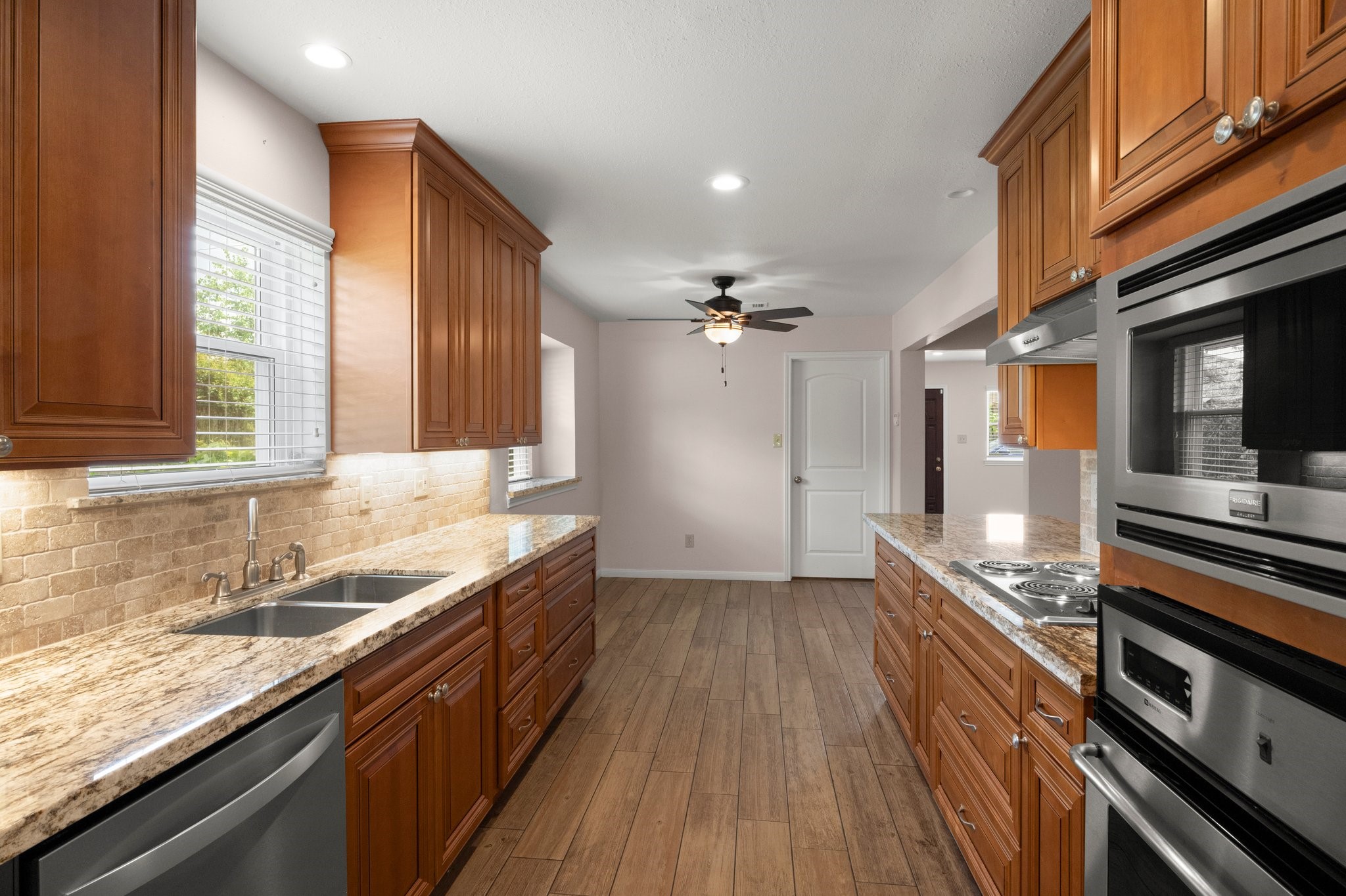 1206 Lynwood Road Spring, TX 77373 - Photo 15 of 29 a kitchen with stainless steel appliances granite countertop a sink and a stove