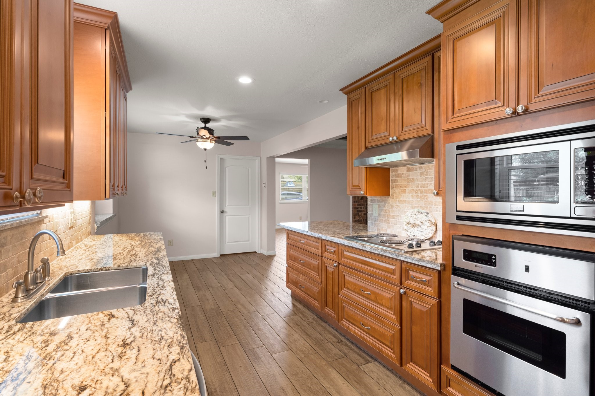 1206 Lynwood Road Spring, TX 77373 - Photo 16 of 29 a kitchen with granite countertop a stove and a sink