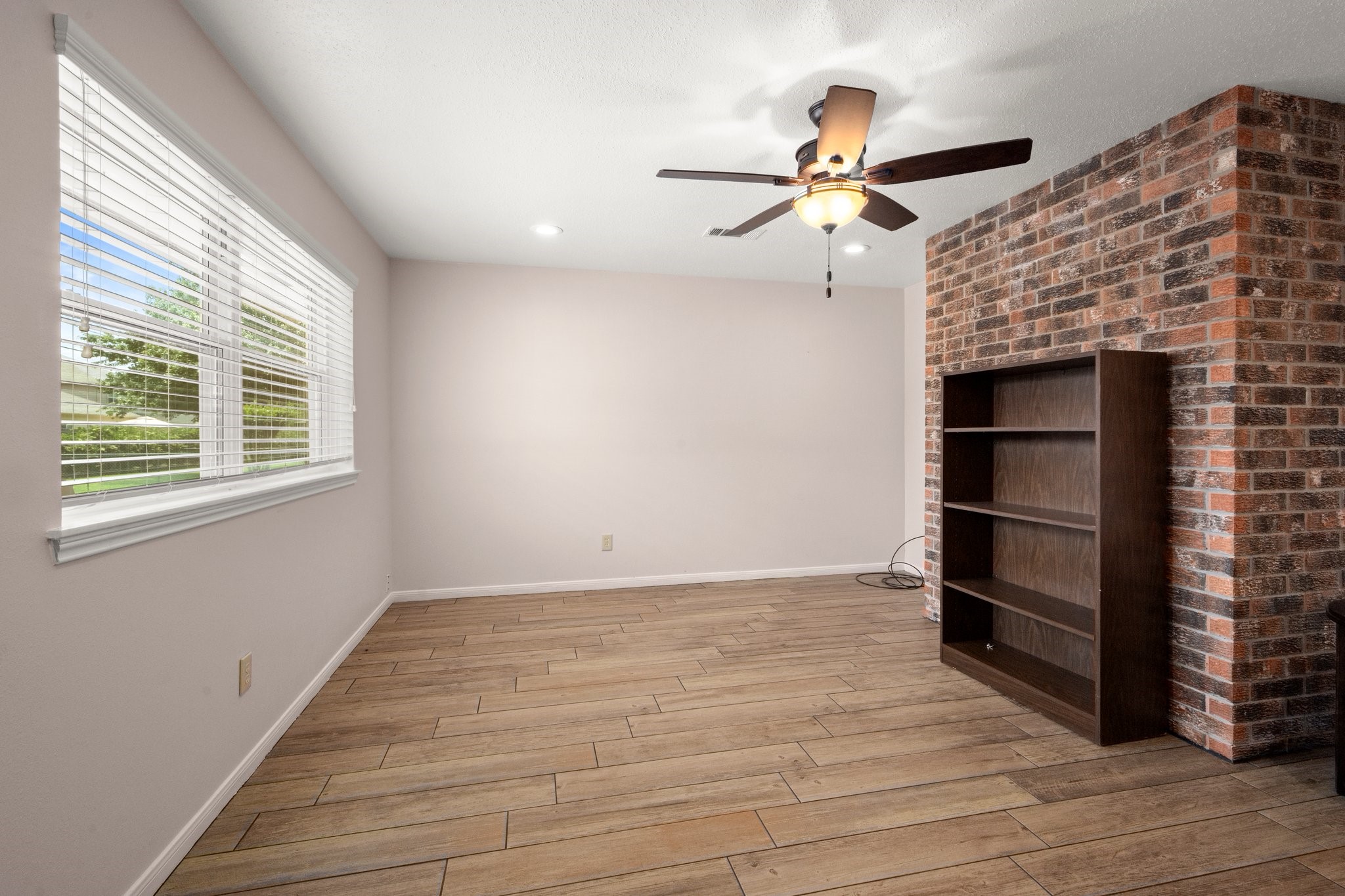 1206 Lynwood Road Spring, TX 77373 - Photo 17 of 29 a view of an empty room with a window and wooden floor