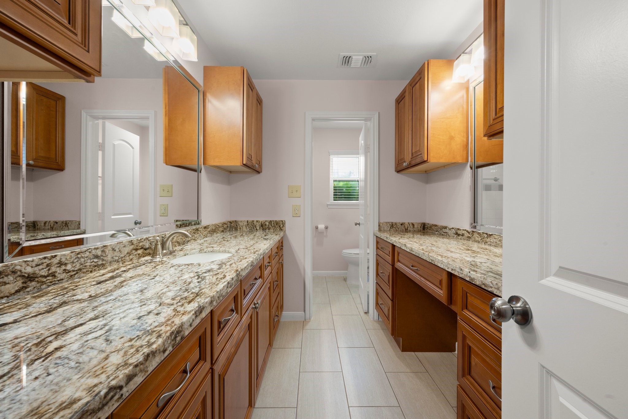 1206 Lynwood Road Spring, TX 77373 - Photo 23 of 29 a spacious bathroom with a granite countertop double vanity and a mirror