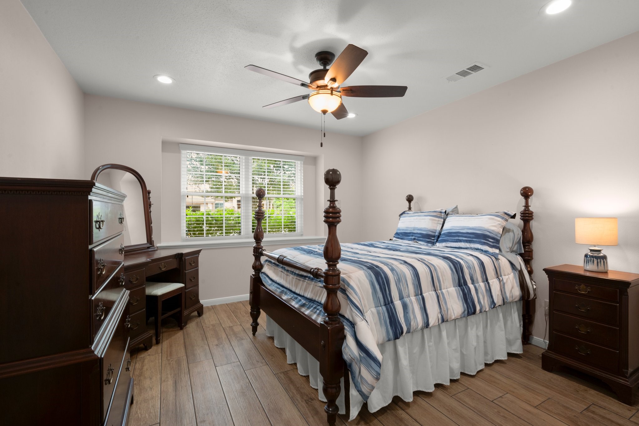 1206 Lynwood Road Spring, TX 77373 - Photo 25 of 29 a bedroom with a bed and a large window with wooden floor
