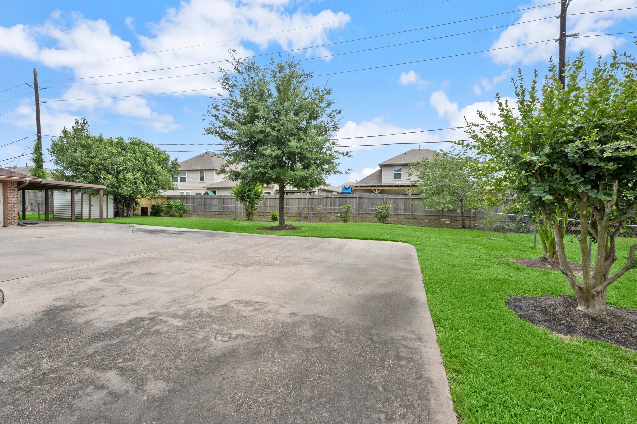 1206 Lynwood Road Spring, TX 77373 - Photo 26 of 29 a view of a house with a big yard and palm trees