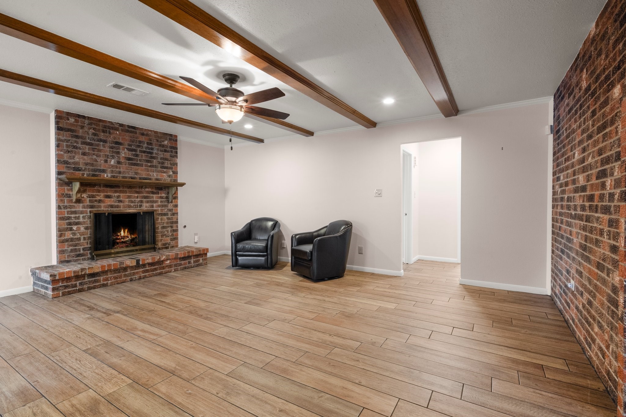 1206 Lynwood Road Spring, TX 77373 - Photo 8 of 29 a view of an empty room with wooden floor fireplace and a window