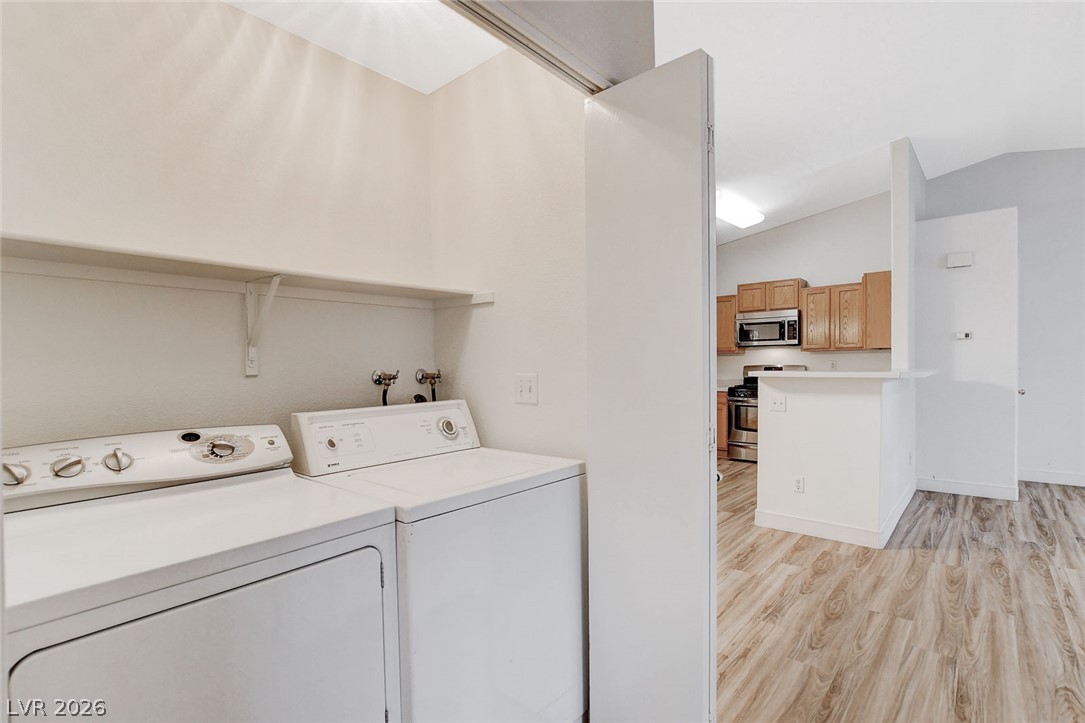 2052 Quarry Ridge Street, Unit 201 Las Vegas, NV 89117 - Photo 21 of 25 Functional laundry facilities with shelving await in this well-appointed space.