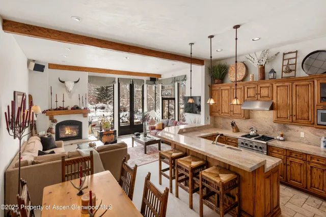 a dinning room with furniture kitchen view and a fireplace