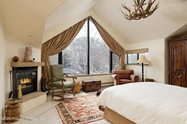 a bedroom with furniture and a fireplace