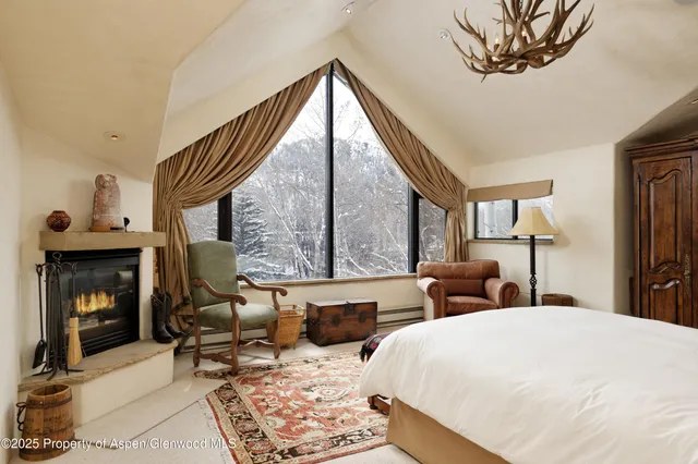 a bedroom with furniture and a fireplace