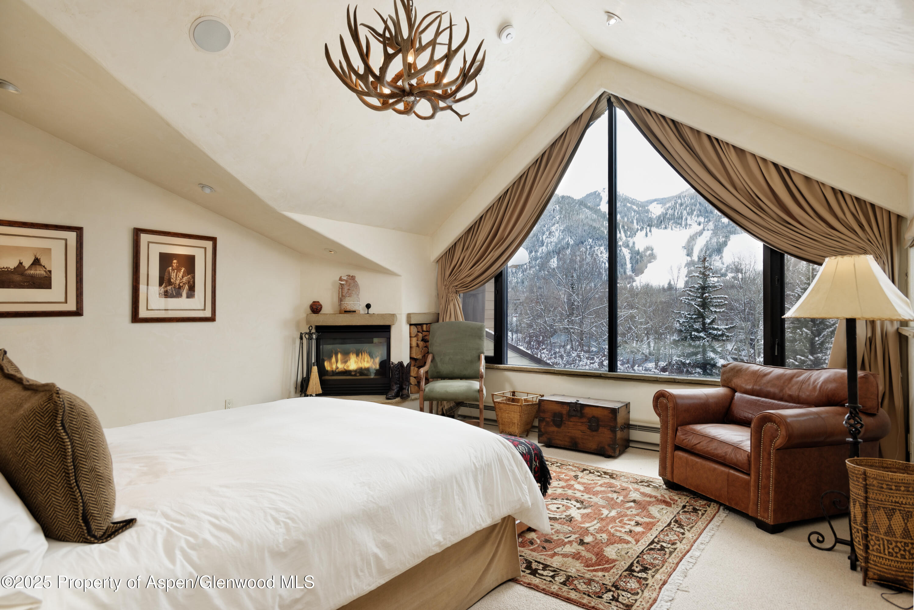 155 Lone Pine Road, Unit 5 Aspen, CO 81611 - Photo 16 of 26 a bedroom with a bed a couch and a large window