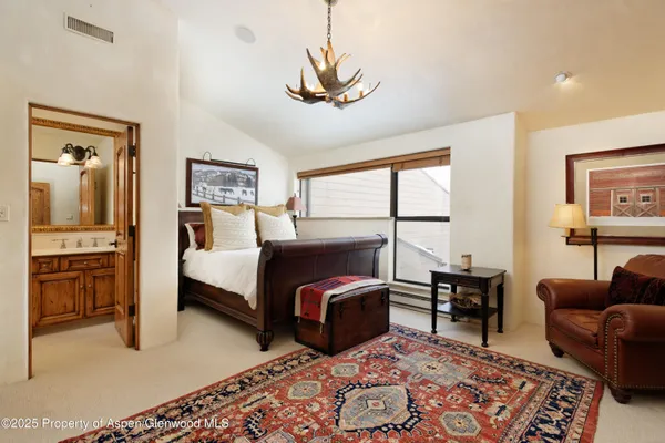 a bedroom with furniture and a dresser