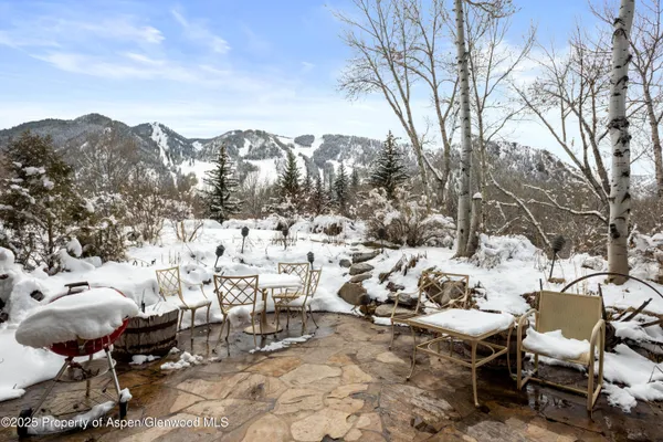 a view of a terrace with chairs and a fire pit