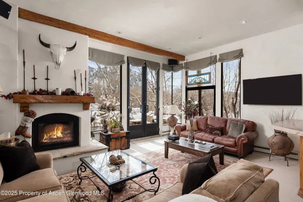 a living room with furniture a fireplace and a flat screen tv