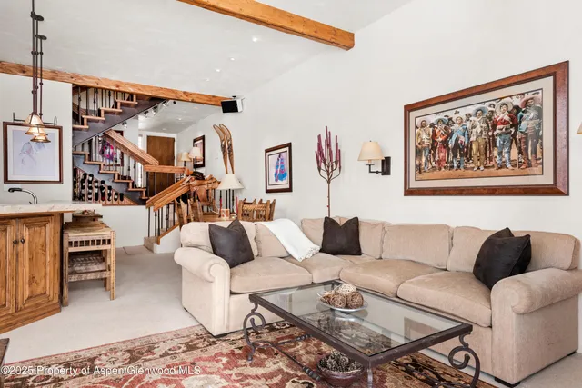 a living room with furniture and a rug