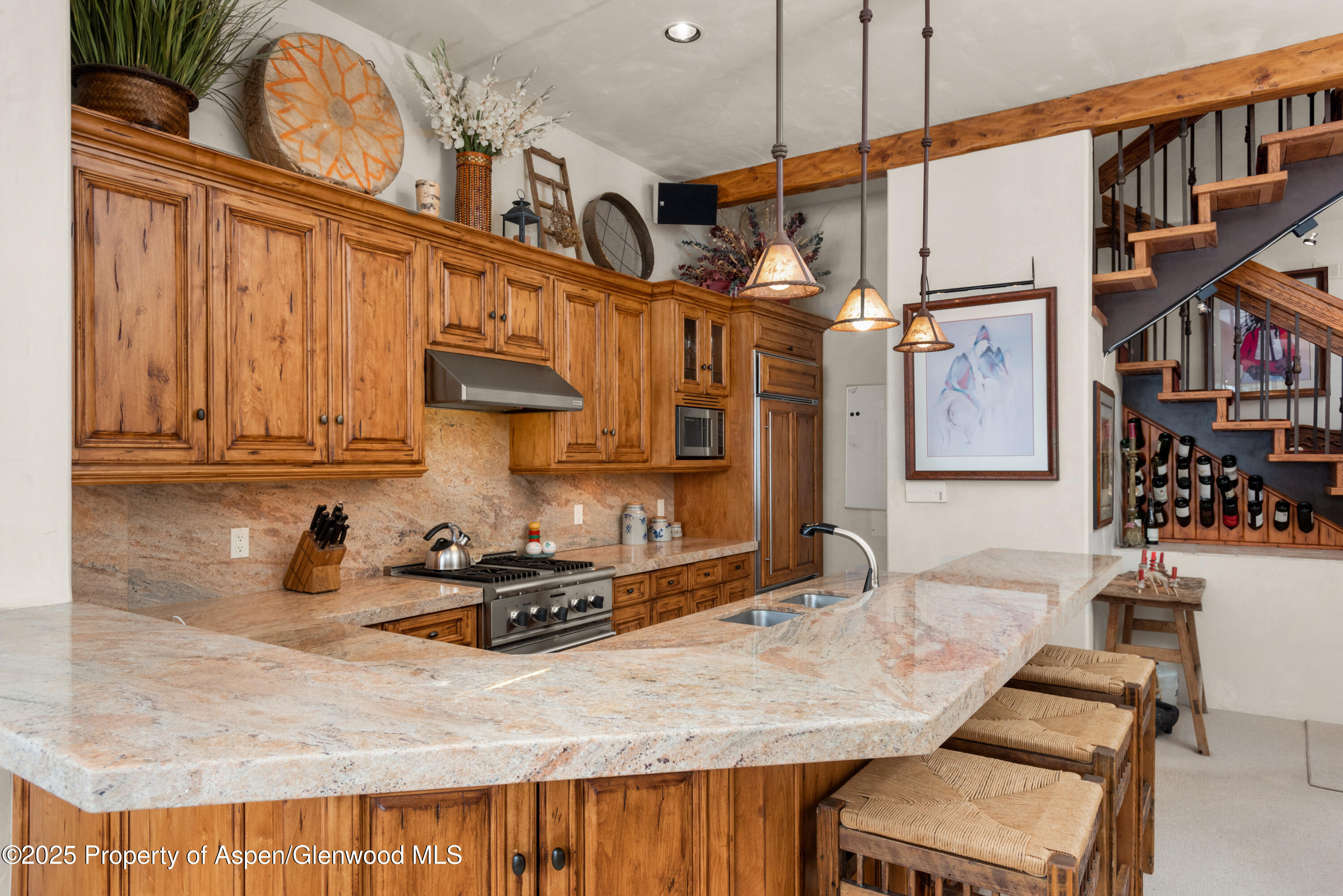 155 Lone Pine Road, Unit 5 Aspen, CO 81611 - Photo 7 of 26 a kitchen with a table chairs stove and cabinets