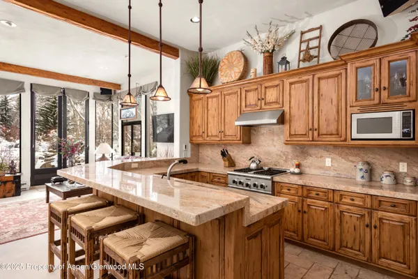 a kitchen with stainless steel appliances granite countertop a stove a sink and a cabinets