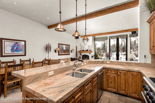 a kitchen with a sink a counter space and a dining table
