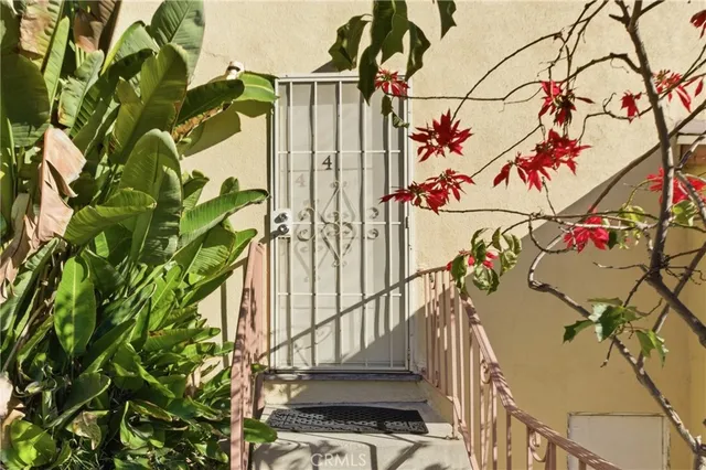 a view of a street with potted plants
