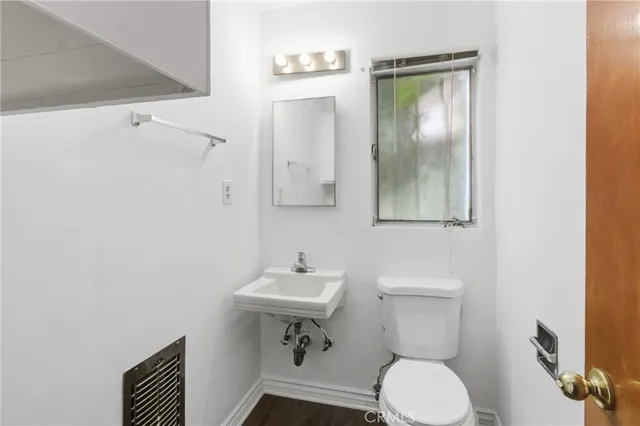 a white toilet sitting next to a bathroom sink