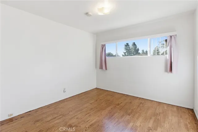 an empty room with a painting on the wall