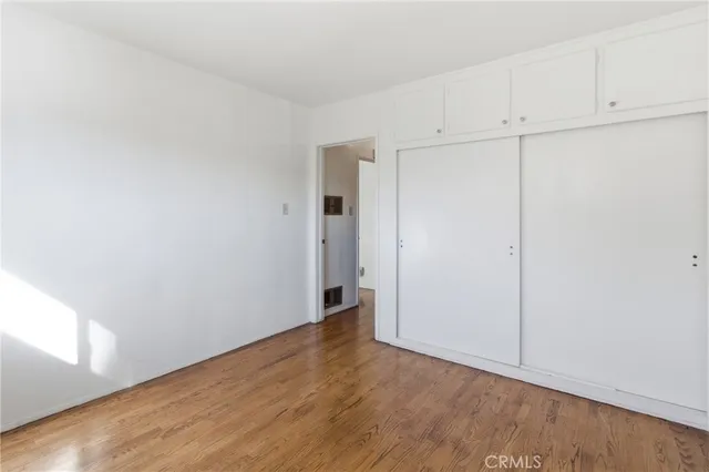 a view of an empty room and closet area