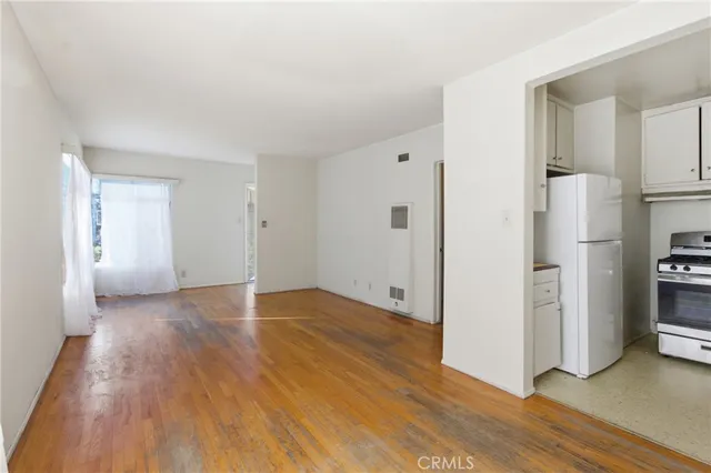 a view of a kitchen with a refrigerator and a stove