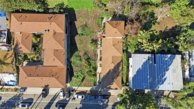 an aerial view of residential house with outdoor space and trees all around