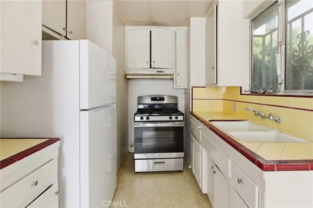 a kitchen with a refrigerator and a sink