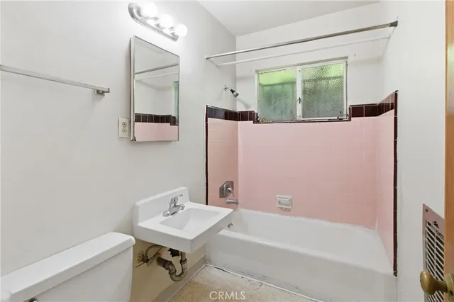 a bathroom with a bathtub a mirror a vanity and a shower