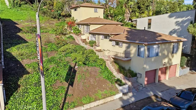 an aerial view of a house with yard