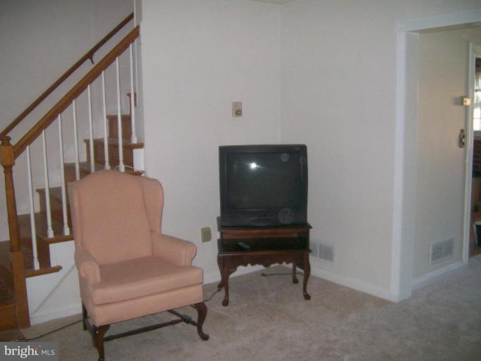 507 Brisbane Road Baltimore, MD 21229 - Photo 9 of 11 a living room with furniture and a chair
