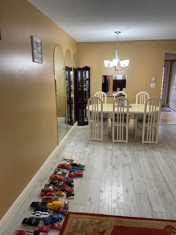 Tamarac Tamarac, FL 33319 - Photo 6 of 8 a view of a dining room with furniture and wooden floor