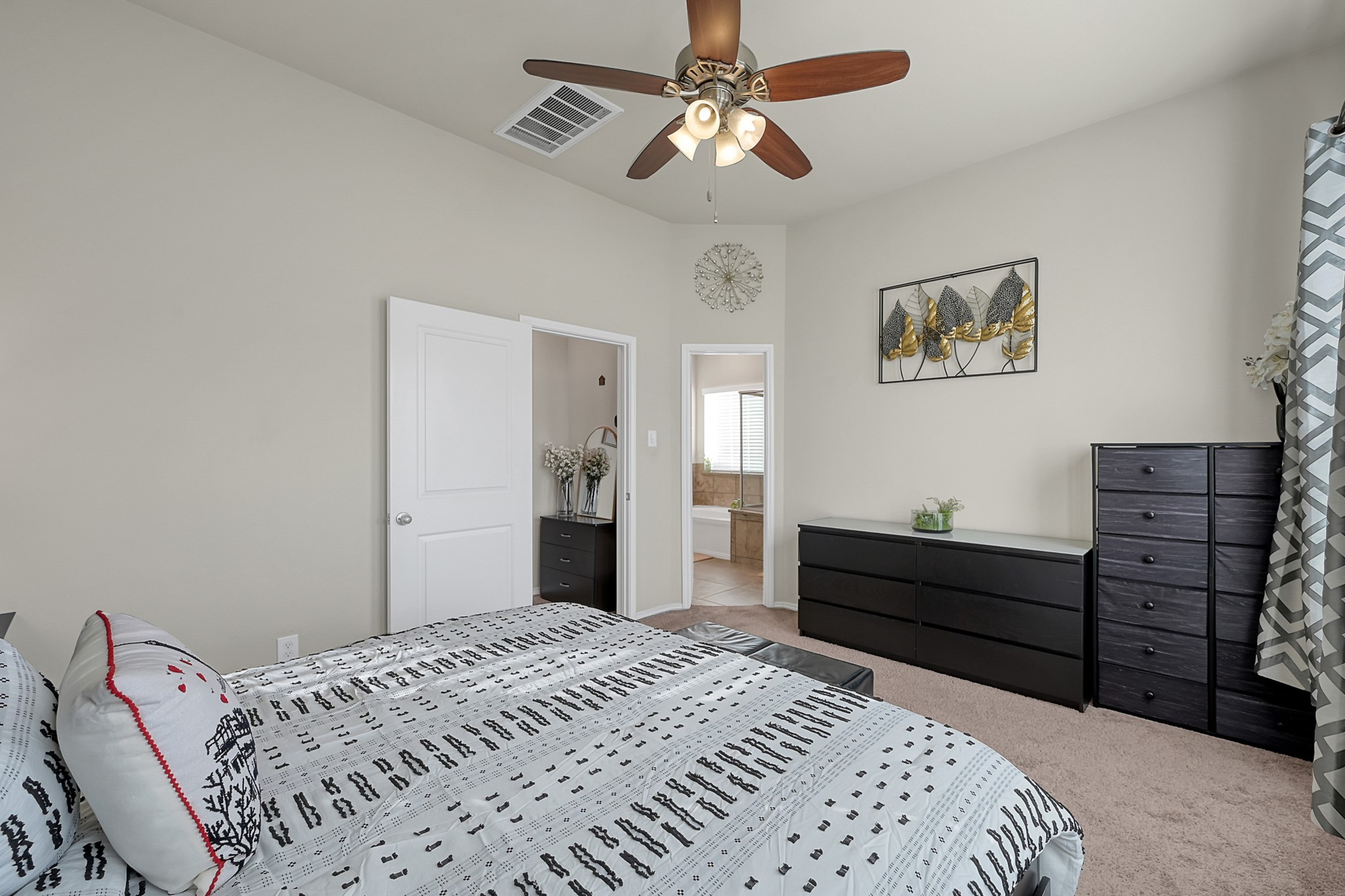 2811 Wilde Redbud Lane Conroe, TX 77385 - Photo 14 of 32 a bedroom with a bed and a chandelier