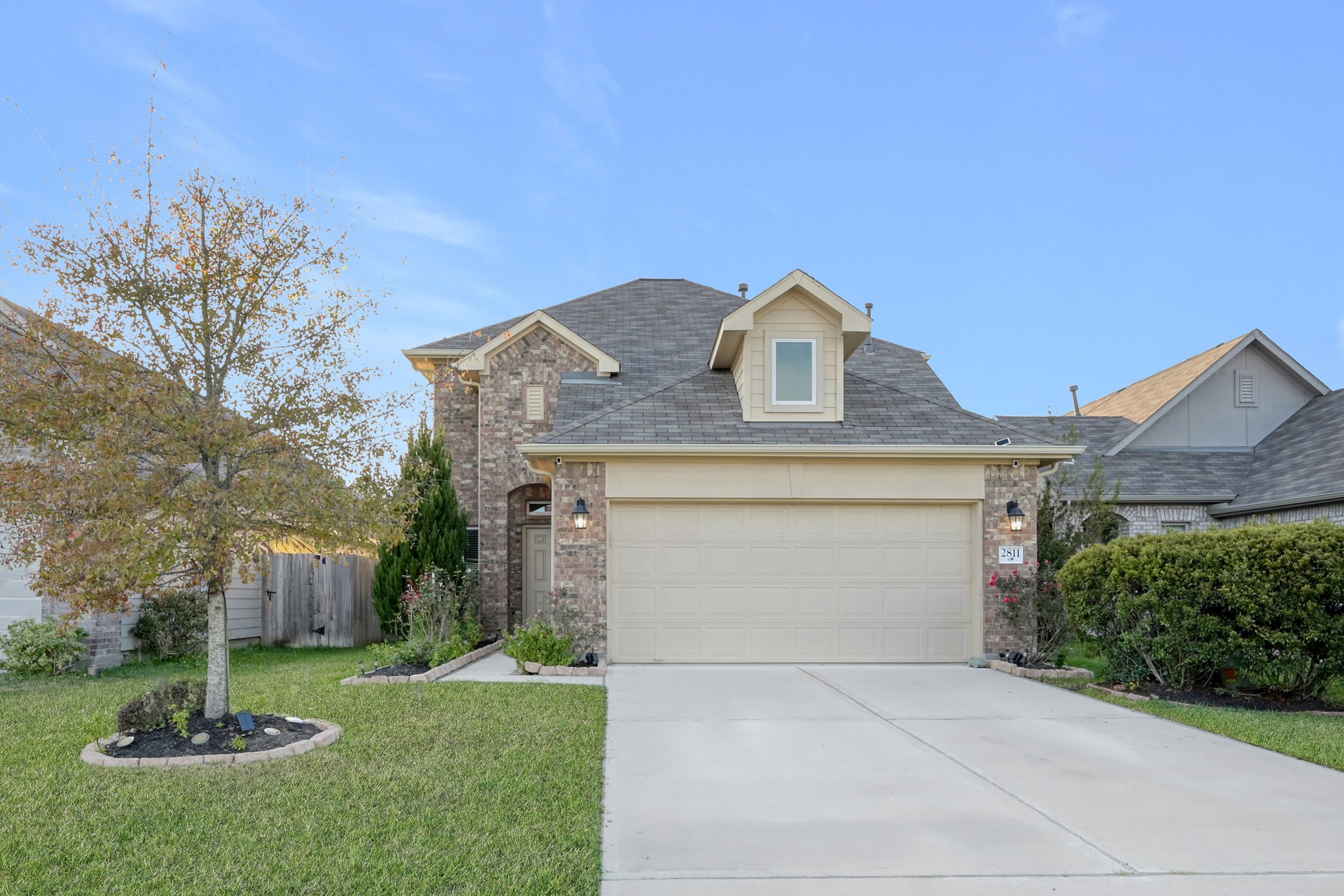 2811 Wilde Redbud Lane Conroe, TX 77385 - Photo 2 of 32 a front view of a house with a yard