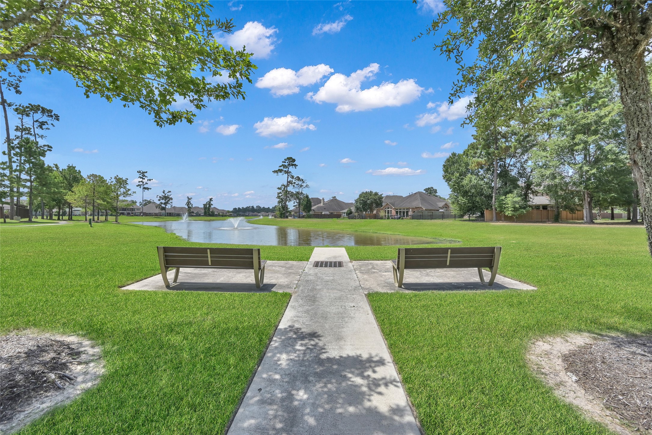 2811 Wilde Redbud Lane Conroe, TX 77385 - Photo 31 of 32 a view of a park with lawn chairs and a large tree